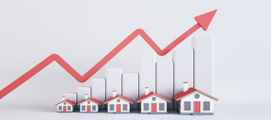Model houses beneath rising bars and an upward arrow illustrating increasing housing costs